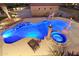 Night aerial view of backyard pool and spa, featuring outdoor lights and patio at 3312 N 89Th Pl, Mesa, AZ 85207
