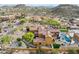 Expansive aerial view of desert home, pool, landscaping, and mountain backdrop in affluent residential neighborhood at 3312 N 89Th Pl, Mesa, AZ 85207