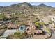 Aerial view of luxurious desert home with a pool, landscaping, desert views, and a three car garage at 3312 N 89Th Pl, Mesa, AZ 85207