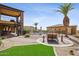 Lush backyard with a pool, guest house, outdoor seating areas and a desert landscape at 3312 N 89Th Pl, Mesa, AZ 85207