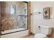 Bathroom featuring a glass-enclosed tub/shower, toilet, and a desert scene visible through a window at 3312 N 89Th Pl, Mesa, AZ 85207
