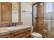 Bathroom with a vanity, toilet, and a shower featuring a glass door at 3312 N 89Th Pl, Mesa, AZ 85207