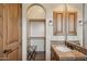 Bathroom vanity with tile countertop and access to a large walk-in closet at 3312 N 89Th Pl, Mesa, AZ 85207