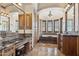 Luxurious bathroom featuring double vanities, tiled flooring, and a beautiful soaking tub with shuttered windows and chandelier at 3312 N 89Th Pl, Mesa, AZ 85207