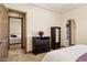 Bedroom featuring a wood door and furniture with a view to an ensuite bathroom and bedroom at 3312 N 89Th Pl, Mesa, AZ 85207