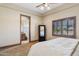 Bedroom featuring neutral walls, ceiling fan and access to an ensuite bathroom at 3312 N 89Th Pl, Mesa, AZ 85207