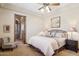 This bedroom is equipped with a ceiling fan, bedside tables, and a lounge chair at 3312 N 89Th Pl, Mesa, AZ 85207