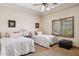 Bedroom featuring two beds, neutral walls, and a shuttered window at 3312 N 89Th Pl, Mesa, AZ 85207