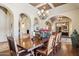 Formal dining room featuring wood flooring, archways, and a large wooden table at 3312 N 89Th Pl, Mesa, AZ 85207