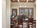 Dining room featuring a chandelier, shutters, and a large floral centerpiece at 3312 N 89Th Pl, Mesa, AZ 85207