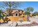 Home exterior showing stone accents, desert landscaping, address marker, and arched entryway at 3312 N 89Th Pl, Mesa, AZ 85207
