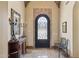 Foyer with stone floors, elegant furnishings, and custom iron work door at 3312 N 89Th Pl, Mesa, AZ 85207