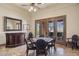 Game room with a bar, mirror, game table, chairs, and doors to the backyard at 3312 N 89Th Pl, Mesa, AZ 85207