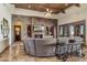 Open living room featuring a stone fireplace, built-in shelves and cabinets, and wood-beamed ceilings at 3312 N 89Th Pl, Mesa, AZ 85207