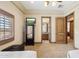 Spacious main bedroom featuring neutral carpet, TV on dresser, and doorway to the ensuite bathroom at 3312 N 89Th Pl, Mesa, AZ 85207