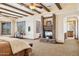 Elegant main bedroom boasting exposed ceiling beams, a brick fireplace, and ample natural light at 3312 N 89Th Pl, Mesa, AZ 85207