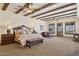 Luxurious main bedroom featuring a king-size bed, seating area, and access to the outdoor patio at 3312 N 89Th Pl, Mesa, AZ 85207