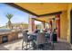 Outdoor kitchen and dining area with built-in grill, modern appliances and outdoor seating at 3312 N 89Th Pl, Mesa, AZ 85207