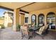 Outdoor patio seating and dining area featuring decorative trim and stone pavers at 3312 N 89Th Pl, Mesa, AZ 85207