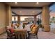 This covered outdoor living space is furnished with a large outdoor table and chairs at 3312 N 89Th Pl, Mesa, AZ 85207