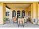 Covered patio area with comfortable seating, arched windows, and tiled flooring for outdoor living at 3312 N 89Th Pl, Mesa, AZ 85207