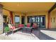 Inviting covered patio featuring a fire pit, comfortable seating, and an outdoor living space at 3312 N 89Th Pl, Mesa, AZ 85207