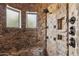 Unique stone shower featuring multiple shower heads and two windows for natural light at 3312 N 89Th Pl, Mesa, AZ 85207