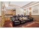 Home theater featuring plush seating, custom wood paneling, and a wet bar area at 3312 N 89Th Pl, Mesa, AZ 85207