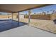 Spacious backyard with covered patio, gravel and block wall fencing, perfect for outdoor living and privacy at 3327 W Mohawk Ln, Phoenix, AZ 85027