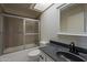 Bathroom featuring shower with glass door and sink with black faucet at 3327 W Mohawk Ln, Phoenix, AZ 85027