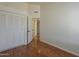 A simple bedroom with wood floors, a closet and a hallway view at 3327 W Mohawk Ln, Phoenix, AZ 85027
