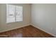 A small bedroom featuring wood flooring and a view from the window at 3327 W Mohawk Ln, Phoenix, AZ 85027