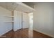 Bedroom featuring wood flooring, closet with shelves and a hallway view at 3327 W Mohawk Ln, Phoenix, AZ 85027
