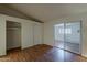 Bedroom with wood-look flooring, closet, and a sliding glass door at 3327 W Mohawk Ln, Phoenix, AZ 85027