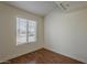 Cozy bedroom with wood flooring and a single window at 3327 W Mohawk Ln, Phoenix, AZ 85027