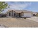 Single-story house featuring a two-car garage, desert landscaping, and covered entry at 3327 W Mohawk Ln, Phoenix, AZ 85027