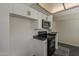 Bright kitchen featuring white cabinets, a black countertop, and modern appliances at 3327 W Mohawk Ln, Phoenix, AZ 85027