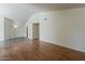 Spacious living room featuring hard wood floors and view into the dining area at 3327 W Mohawk Ln, Phoenix, AZ 85027