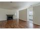 Spacious living room featuring a cozy fireplace and wood-look flooring at 3327 W Mohawk Ln, Phoenix, AZ 85027