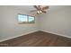 Bedroom with laminate flooring, ceiling fan, and natural light from the window at 352 E Beatryce St, Tempe, AZ 85288