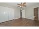 Main bedroom with laminate flooring, ceiling fan, and double door closet at 352 E Beatryce St, Tempe, AZ 85288
