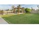 Expansive green lawn with a pergola-covered patio area next to the swimming pool at 3907 W Sharon Ave, Phoenix, AZ 85029