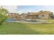 Backyard features a sparkling pool, spacious lawn, shade pergola, and mature trees at 3907 W Sharon Ave, Phoenix, AZ 85029