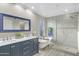 Bathroom showcasing a double vanity, soaking tub, and tiled walk-in shower for a spa-like experience at 3907 W Sharon Ave, Phoenix, AZ 85029