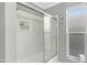 Bright bathroom highlighting a shower/tub combo with sliding glass door, and neutral tile at 3907 W Sharon Ave, Phoenix, AZ 85029