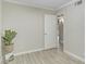 Bright room with wood-look floors, neutral walls, white trim, and a peek into the hallway at 3907 W Sharon Ave, Phoenix, AZ 85029