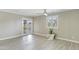 Bright bedroom featuring wood-look tile floors, ceiling fan, and sliding glass door to the backyard at 3907 W Sharon Ave, Phoenix, AZ 85029