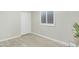 Neutral bedroom with wood-look tile floors, a ceiling fan, and white shuttered window at 3907 W Sharon Ave, Phoenix, AZ 85029