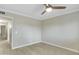 Bedroom with wood-look tile floors, a ceiling fan, and views to an attached hallway at 3907 W Sharon Ave, Phoenix, AZ 85029