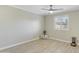 Bedroom with light walls and wood-look tile floors with ceiling fan and shuttered window at 3907 W Sharon Ave, Phoenix, AZ 85029